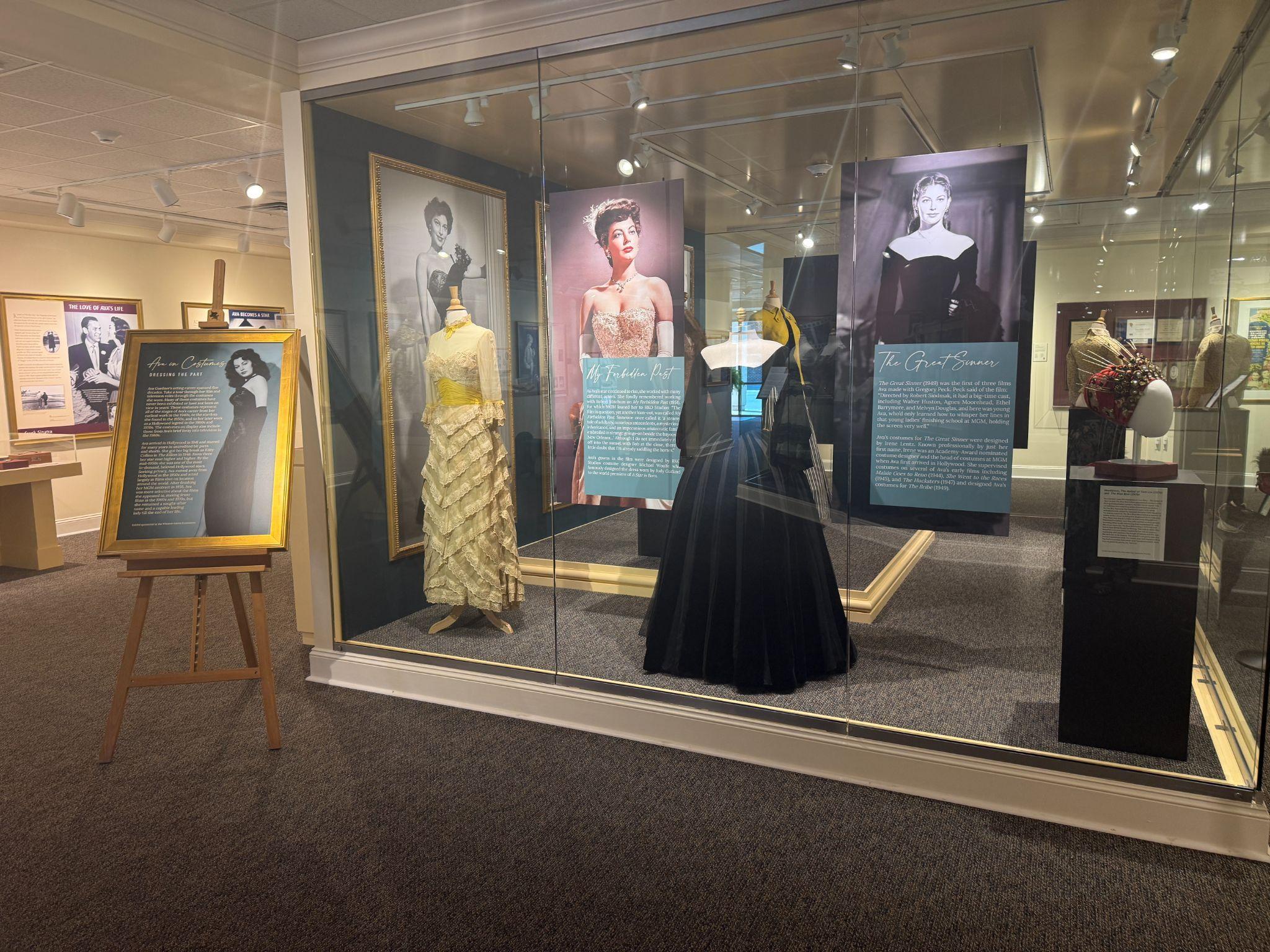 Glass display case of Ava Gardner's film gowns and portraits inside the Ava Gardner Museum in Smithfield