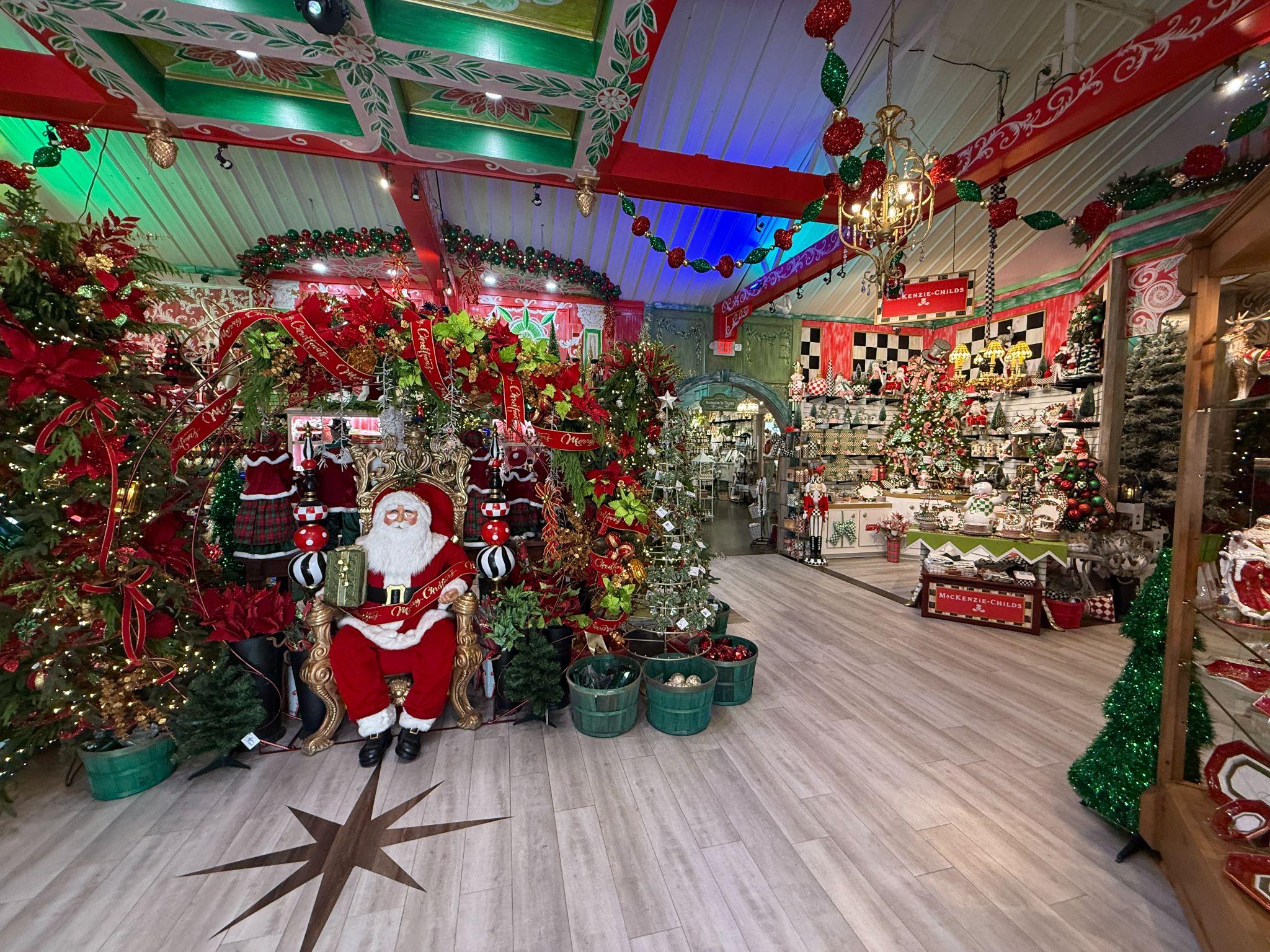 Christmas Land at DeWayne's — a year-round Christmas shop packed with trees, ornaments, garland, and a seated Santa display