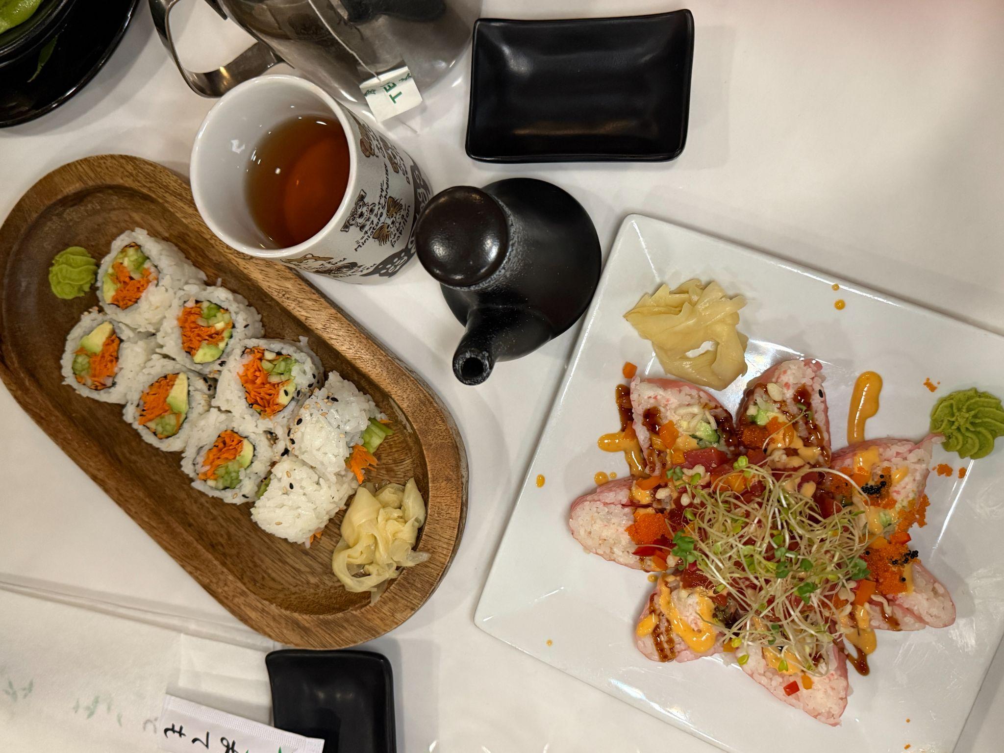Sushi rolls and a specialty roll with a pot of hot tea at a downtown New Bern sushi bar
