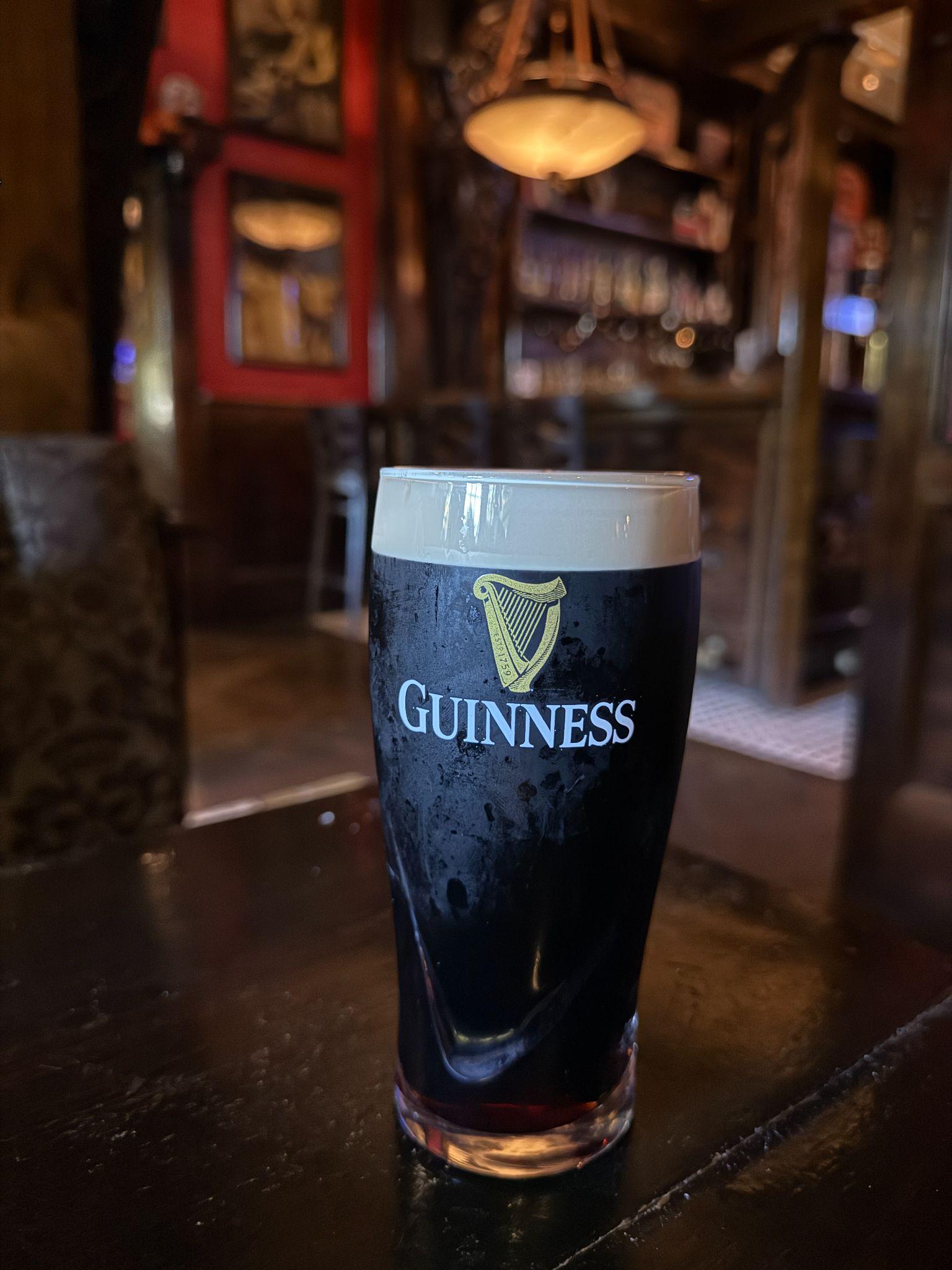 Pint of Guinness on a wooden bar inside Hibernian Irish Pub in Raleigh
