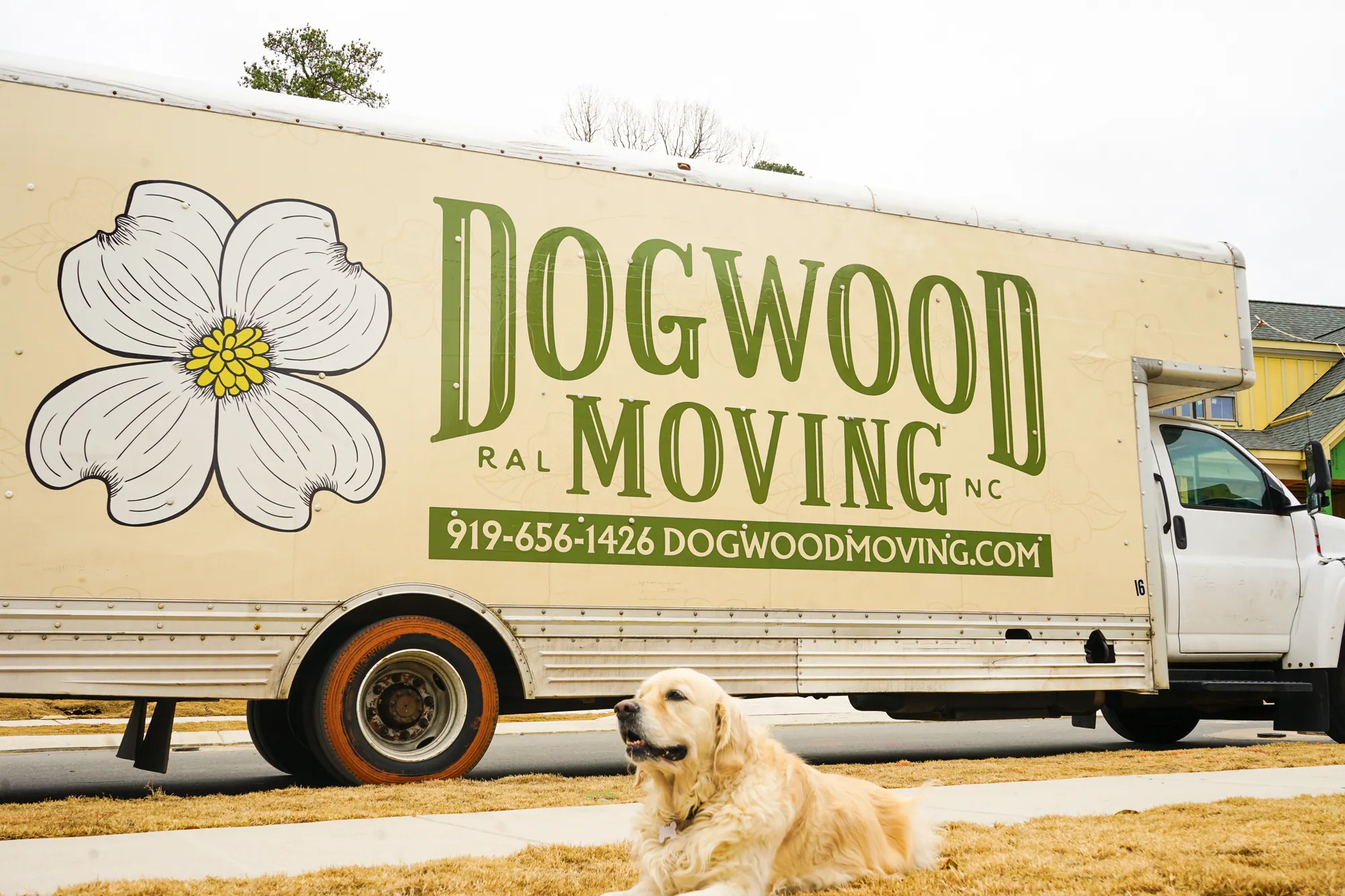 Dogwood Moving truck with a golden retriever resting in front